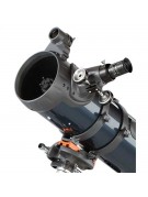 Close-up of optical tube showing red dot finder, focuser, eyepiece, dovetail mount, and secondary mirror collimation screws.